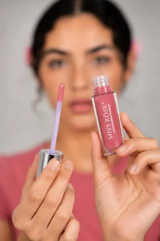 Lip gloss close-up held to camera